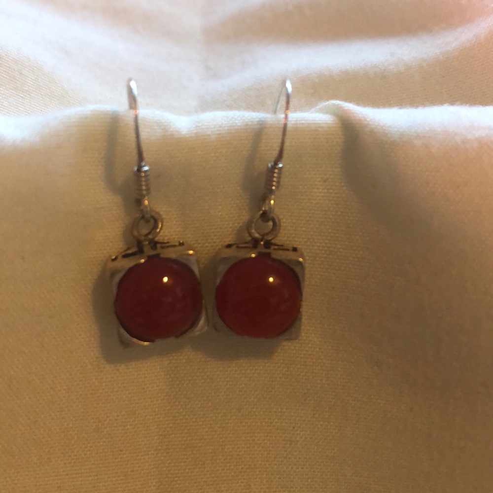 Dainty orange drop earrings on silver